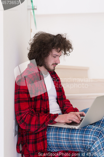 Image of freelancer in bathrobe working from home