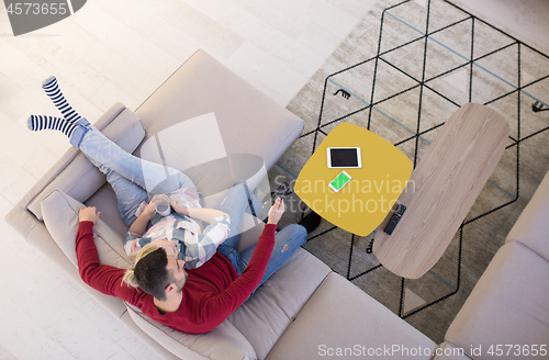 Image of Young couple on the sofa watching television