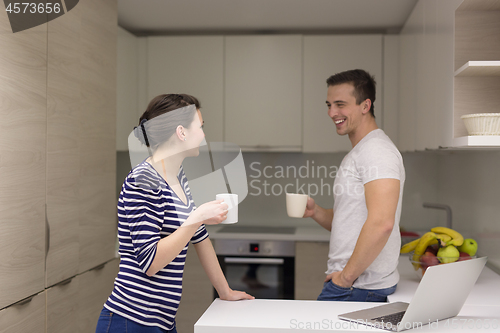 Image of couple with laptop computer enjoying morning