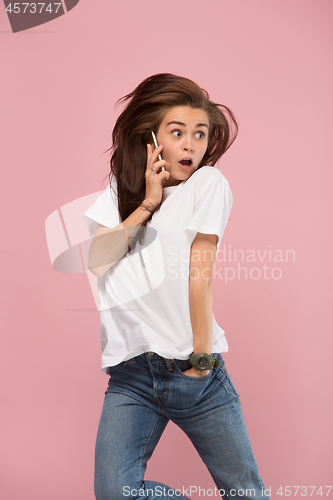 Image of Full length of pretty young woman with mobile phone while jumping