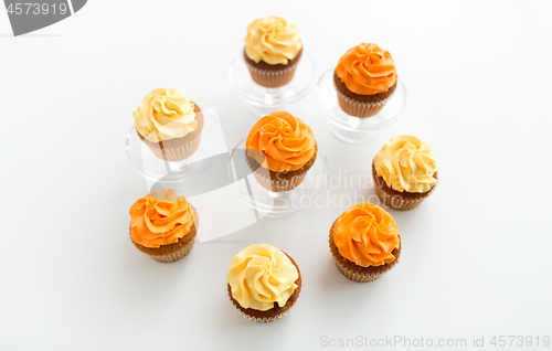 Image of cupcakes with frosting on confectionery stands