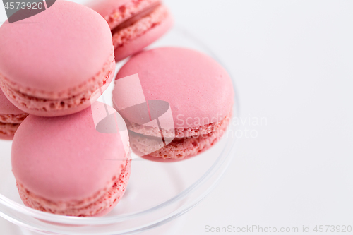 Image of close up of pink macarons on confectionery stand