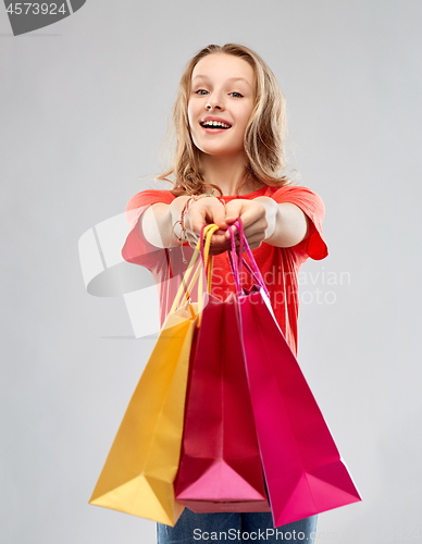 Image of smiling teenage girl with shopping bags