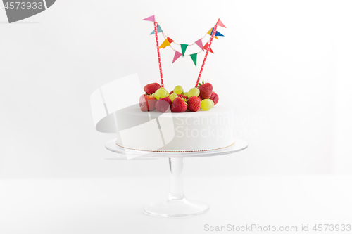 Image of close up of birthday cake with garland on stand