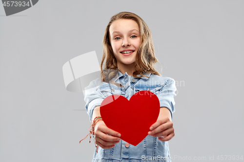 Image of smiling teenage girl with red heart