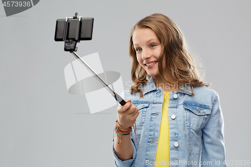 Image of teenage girl taking selfie by smartphone