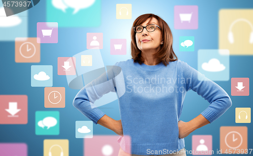 Image of displeased senior woman in glasses over app icons