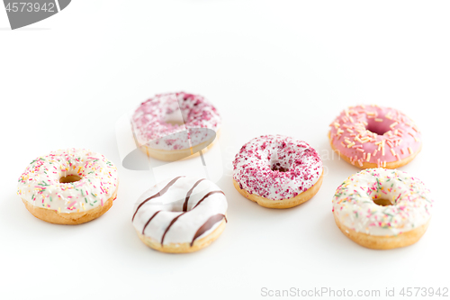 Image of close up of glazed donuts on white table