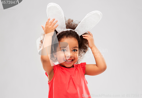 Image of happy little girl wearing easter bunny ears