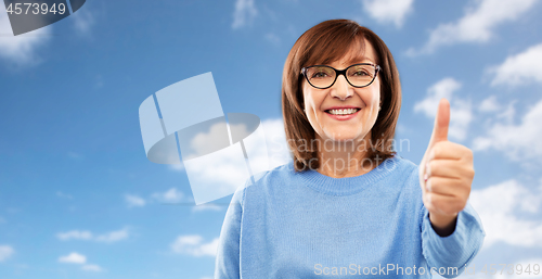 Image of portrait of senior woman showing thumbs up