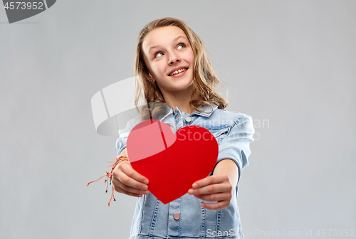 Image of smiling teenage girl with red heart