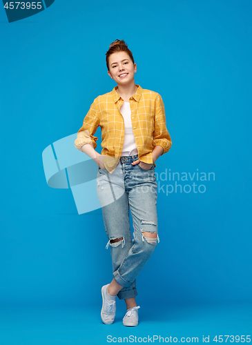 Image of red haired teenage girl in shirt and torn jeans