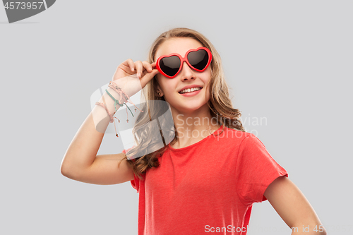 Image of happy teenage girl in red heart shaped sunglasses