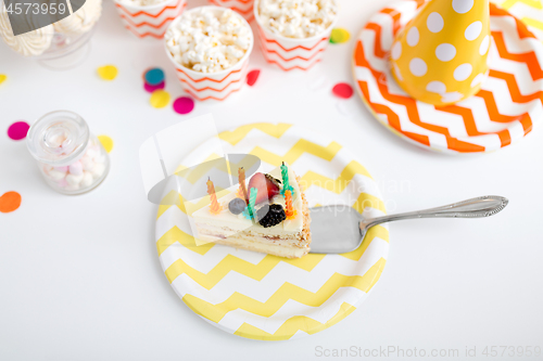 Image of piece of cake on plate at birthday party
