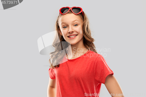 Image of happy teenage girl in red heart shaped sunglasses