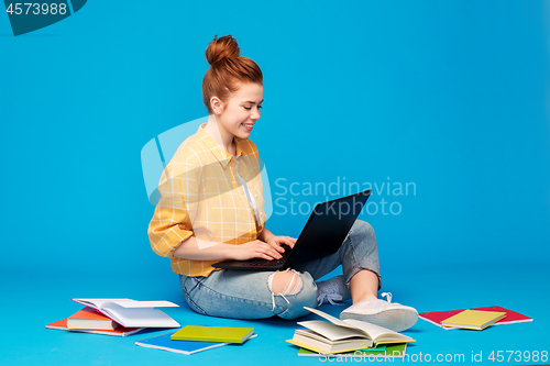 Image of red haired teenage student girl with laptop