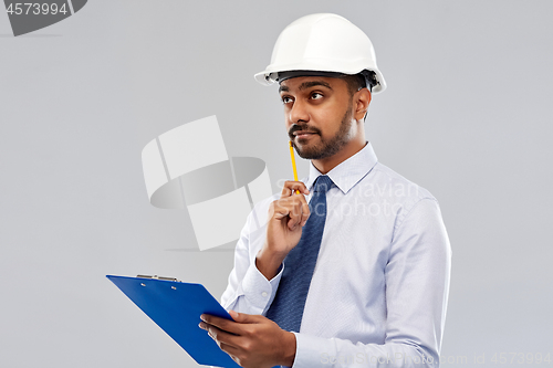 Image of architect or businessman in helmet with clipboard