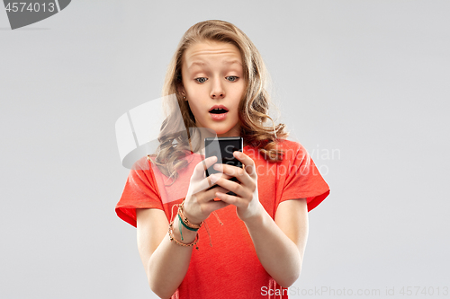 Image of terrified teenage girl using smartphone