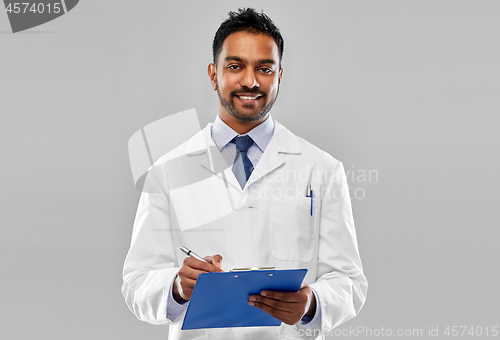 Image of smiling indian doctor or scientist with clipboard