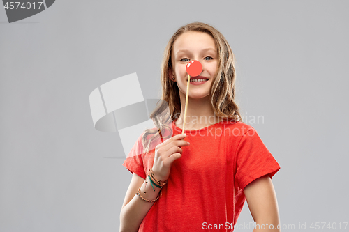 Image of smiling teenage girl with red clown nose