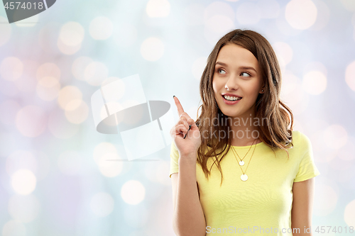 Image of young woman or teenage girl pointing finger up