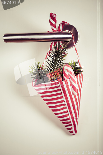 Image of Small Christmas bag with branch and candy cane hanging on door handle