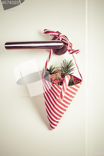 Image of Small Christmas bag with branch and candy cane hanging on door handle