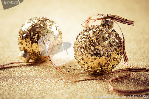 Image of Golden christmas balls on glitter background with copy space