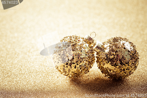 Image of Golden christmas balls on glitter background with copy space