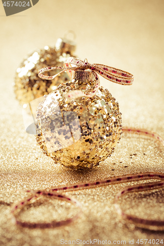 Image of Golden christmas balls on glitter background with copy space