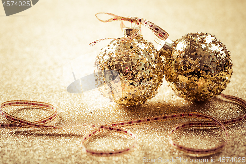 Image of Golden christmas balls on glitter background with copy space