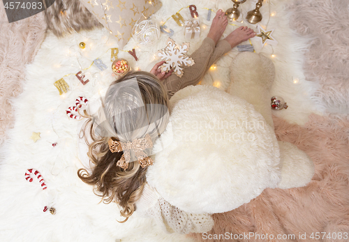 Image of Female holds a snowflake Christmas ornament for the tree