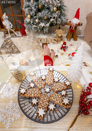 Image of Christmas food and lots of Christmas decorations in front of Christmas tree