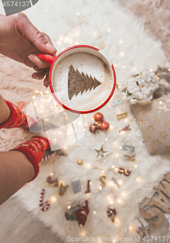 Image of Festive Cappuccino with Christmas tree and decorations
