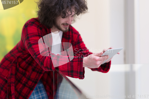 Image of young freelancer using tablet computer