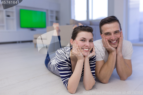 Image of couple lying on the floor at home