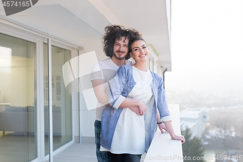 Image of Couple hugging on the balcony