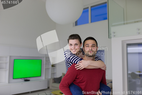 Image of handsome man piggybacking his girlfriend