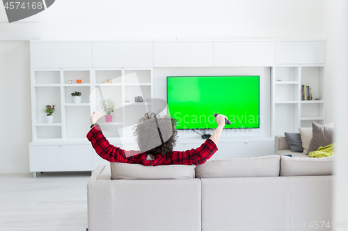 Image of young man in bathrobe enjoying free time