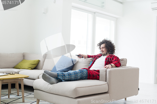 Image of young man in bathrobe enjoying free time