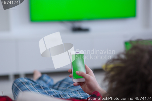 Image of young man in bathrobe enjoying free time