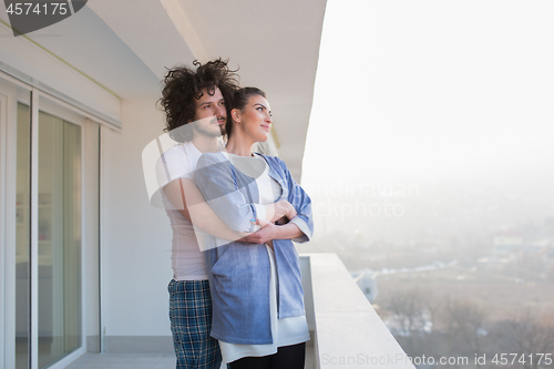 Image of Couple hugging on the balcony
