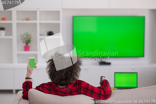 Image of young man in bathrobe enjoying free time