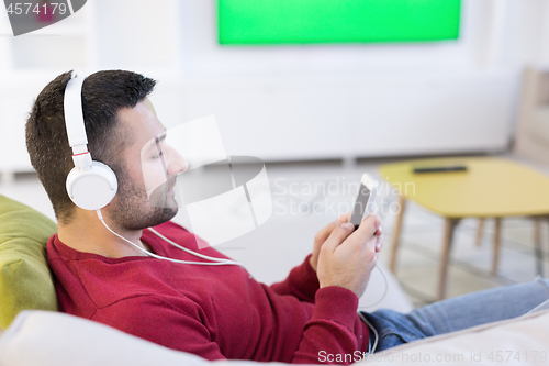 Image of man enjoying music through headphones