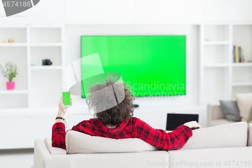 Image of young man in bathrobe enjoying free time