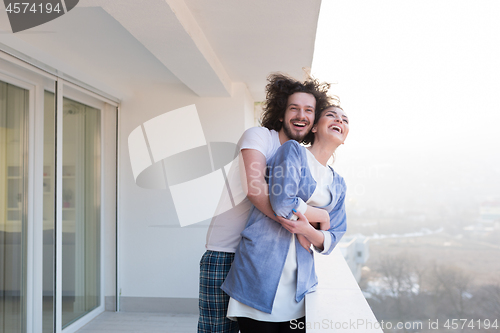 Image of Couple hugging on the balcony