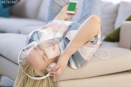 Image of girl enjoying music through headphones