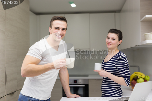 Image of couple with laptop computer enjoying morning