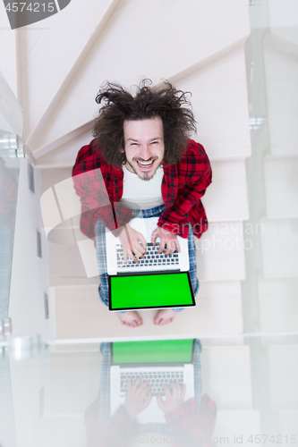 Image of freelancer in bathrobe working from home