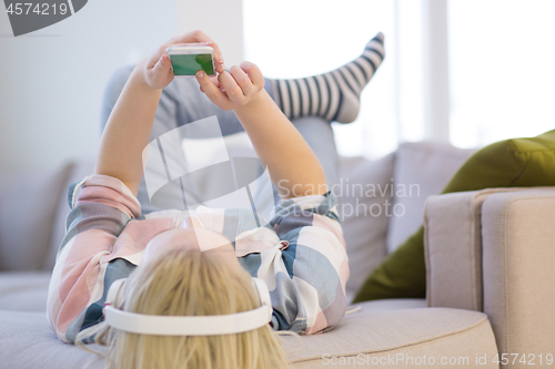 Image of girl enjoying music through headphones